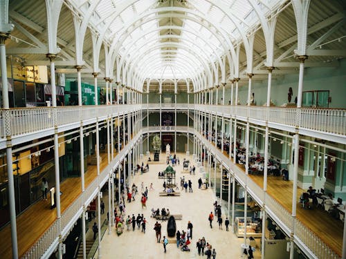 People Walking on Hallway Inside Building