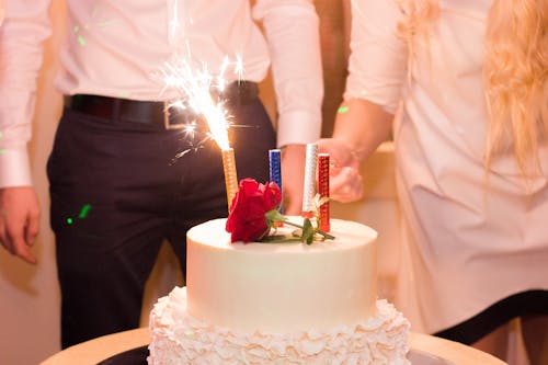 White Cake With Lighted Candles