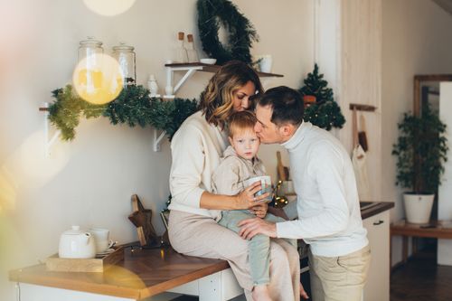 Free A loving family moment in the kitchen decorated for Christmas. Cozy and heartfelt. Stock Photo