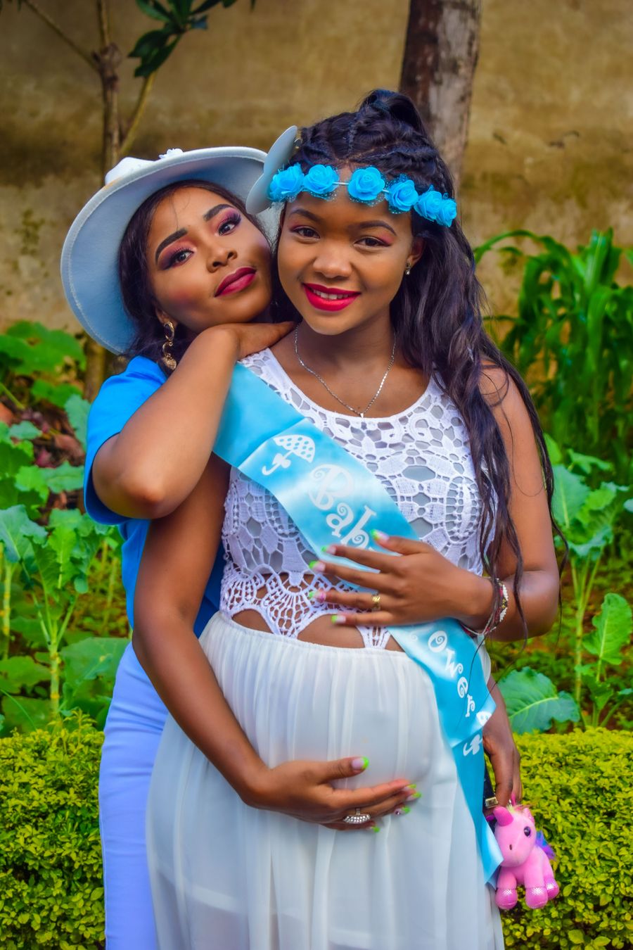 Expectant African mother sharing a baby shower moment with family