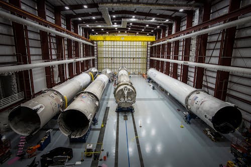 Free Various huge metal details and fragments of unfinished rocket located in contemporary assembly factory Stock Photo