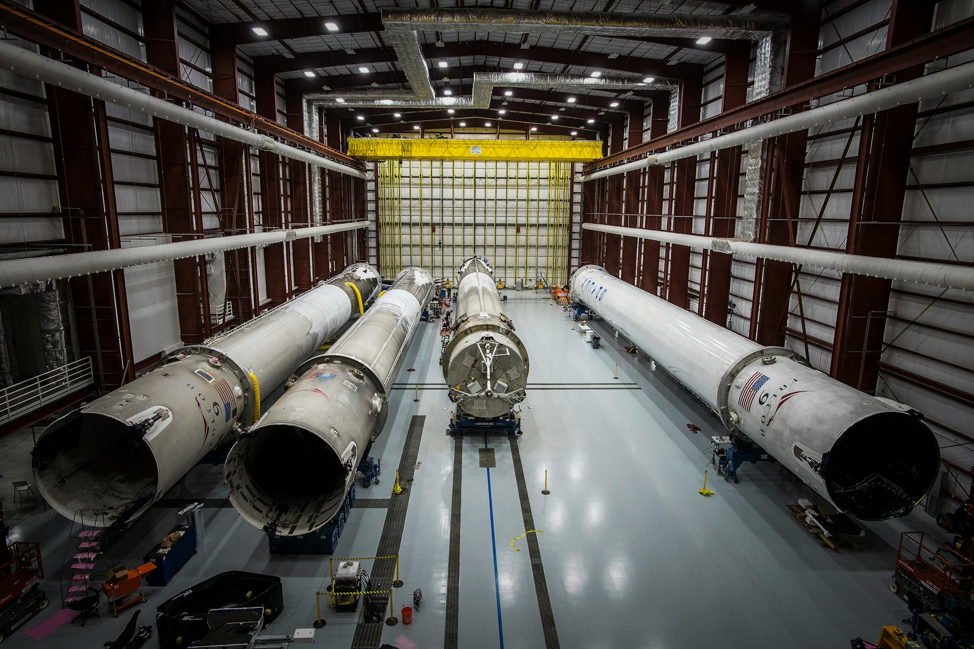 Various huge metal details and fragments of unfinished rocket located in contemporary assembly factory