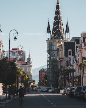 Beautiful urban street view showcasing elegant Gothic-style architecture on a sunny day.