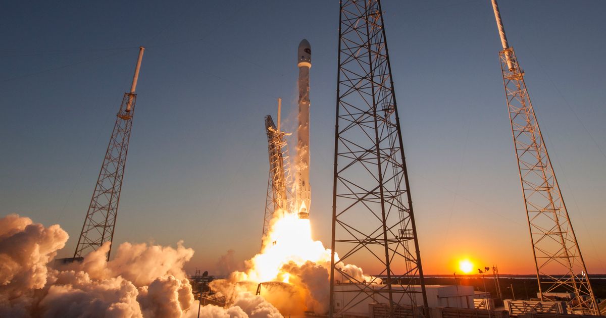 A rocket launching into orbit at sundown.