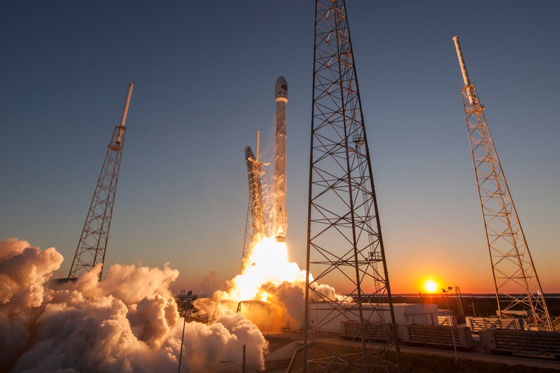 Free Spacecraft launching into orbit during sundown Stock Photo