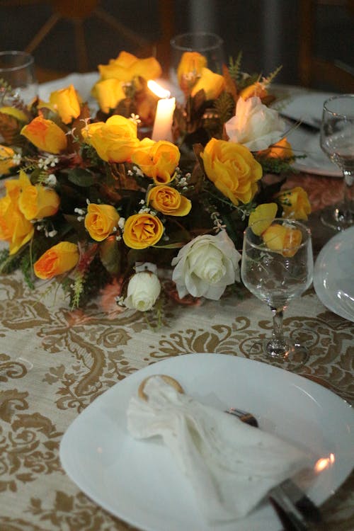 Free Yellow Flowers on Table with Candlelight Stock Photo