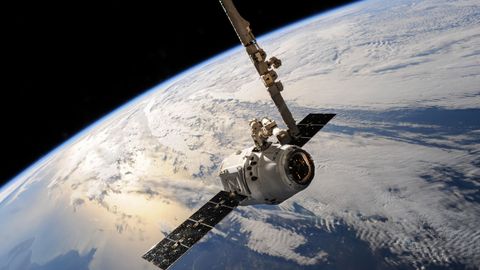 A satellite glides over Earth showcasing dramatic cloud formations and the vast expanse of space.