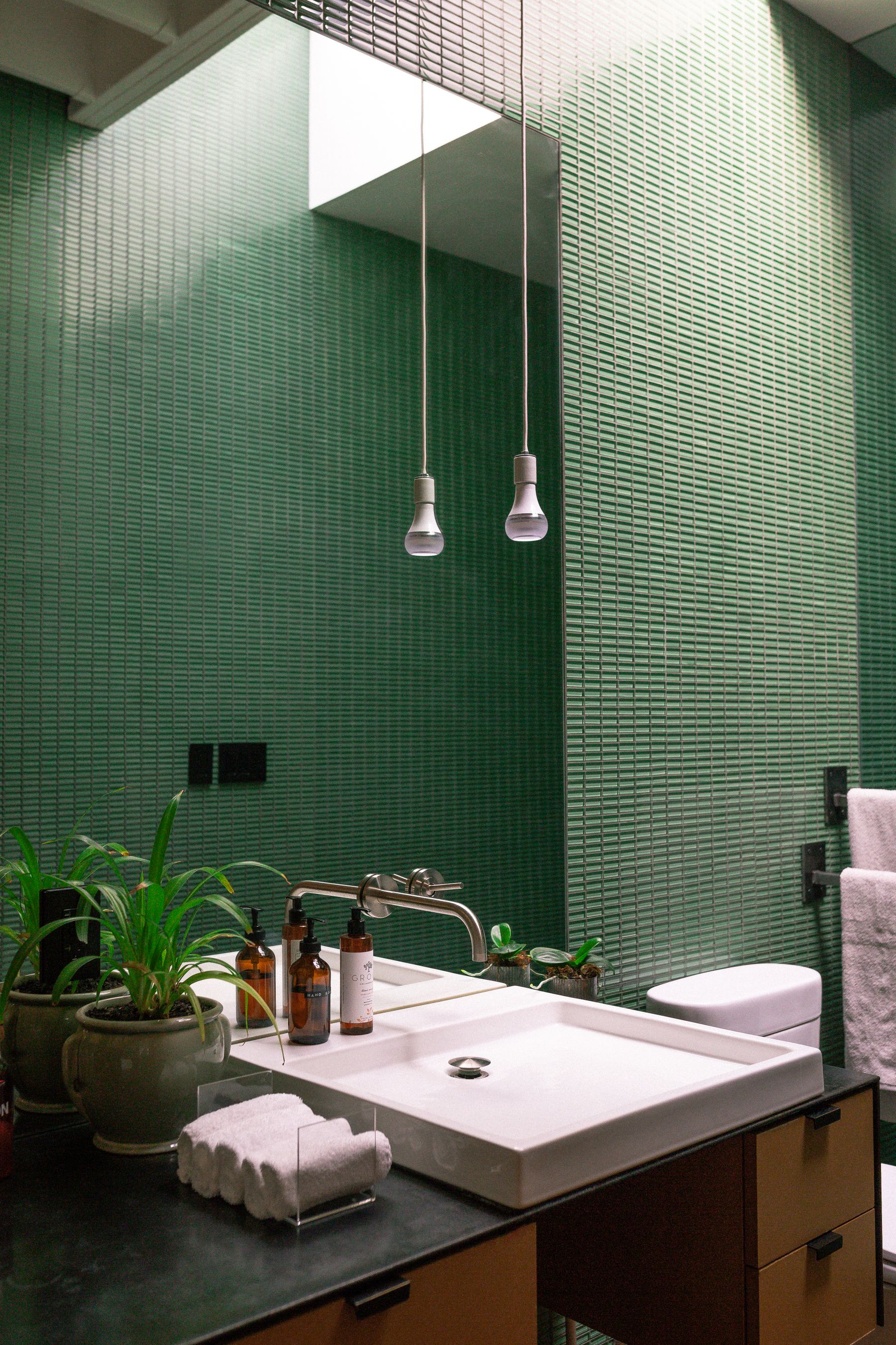 Modern bathroom with wood paneling, sink and large mirror