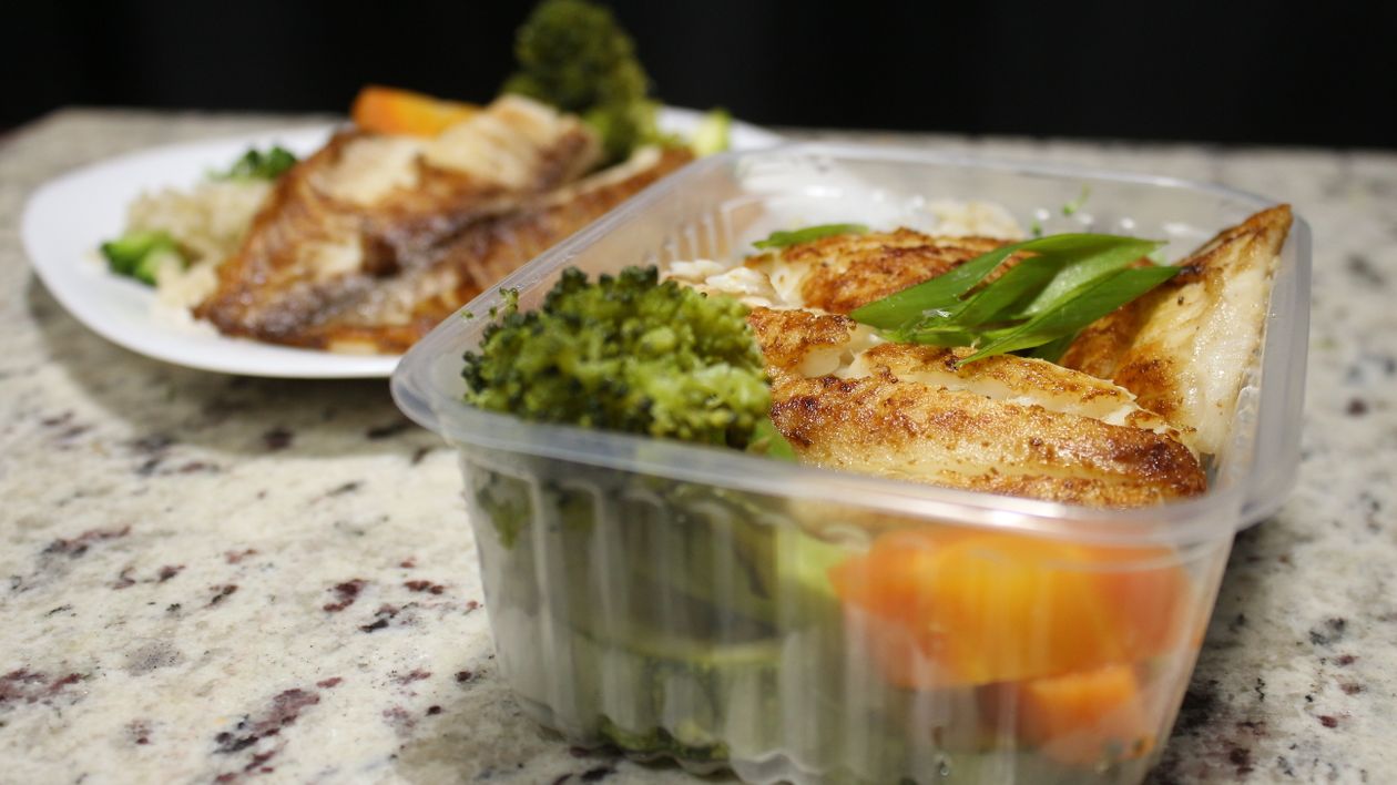 Fried Fish Fillet with Green Vegetable in White Plastic Container ...