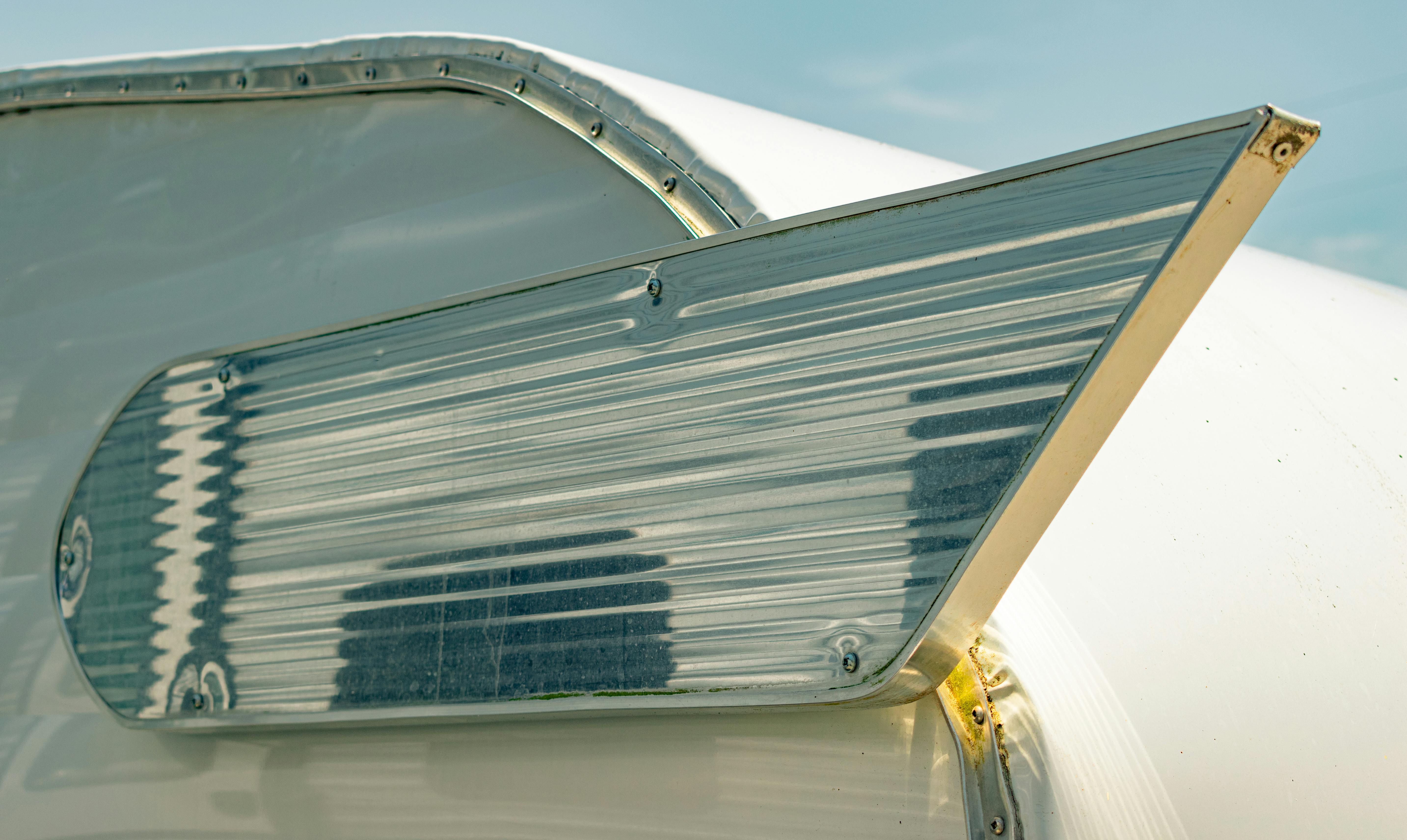 Close-up of clogged condenser fins showing dirt and debris buildup - dirty condenser coil and ac performance connection