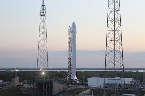 Free Space rocket installed on metal construction in spaceport and ready for launching against cloudless sky Stock Photo