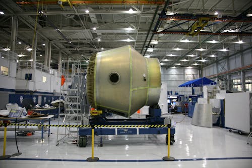 Free Heavy detail of spacecraft placed on rolling platform under construction at futuristic rocket factory Stock Photo