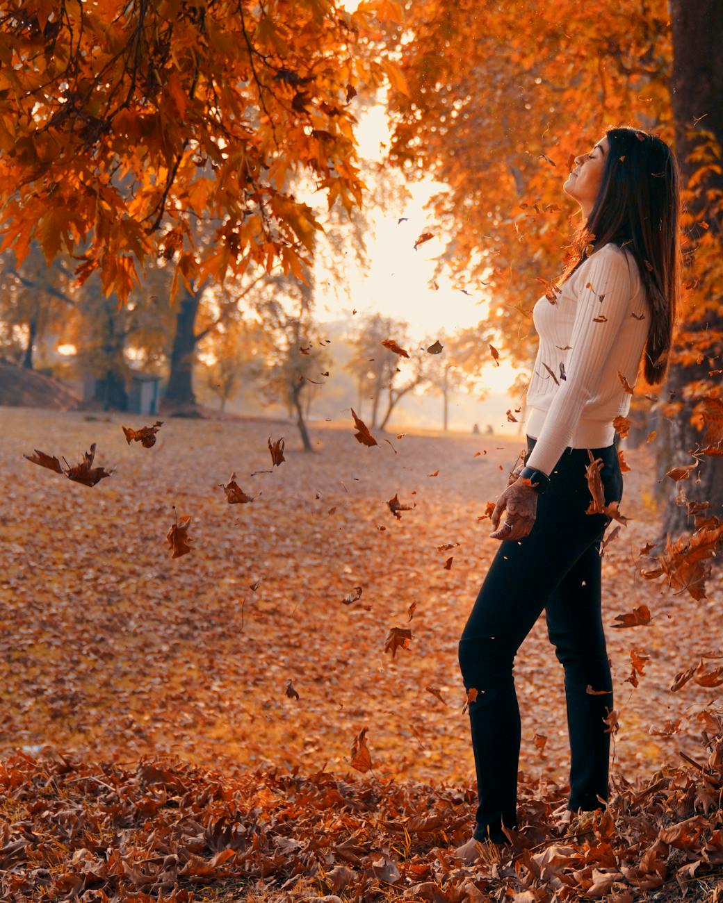 Woman in White Jacket and Black Pants Standing on Brown Dried Leaves ...