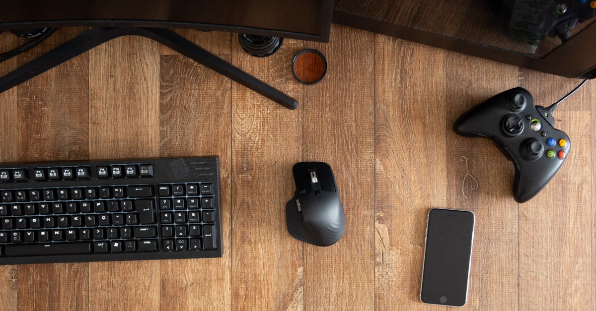 An unfinished notebook beside a game controller on desk
