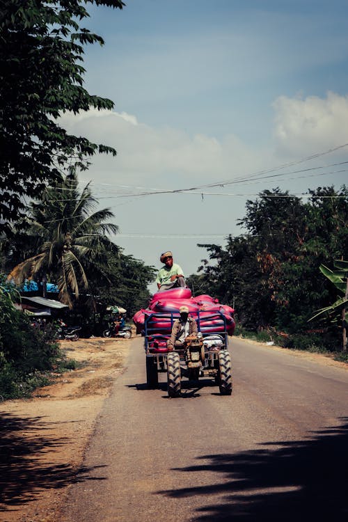 Men Transporting Large Bottles on Motorcycle