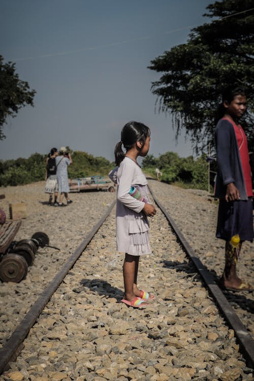 Girl Standing on Tracks