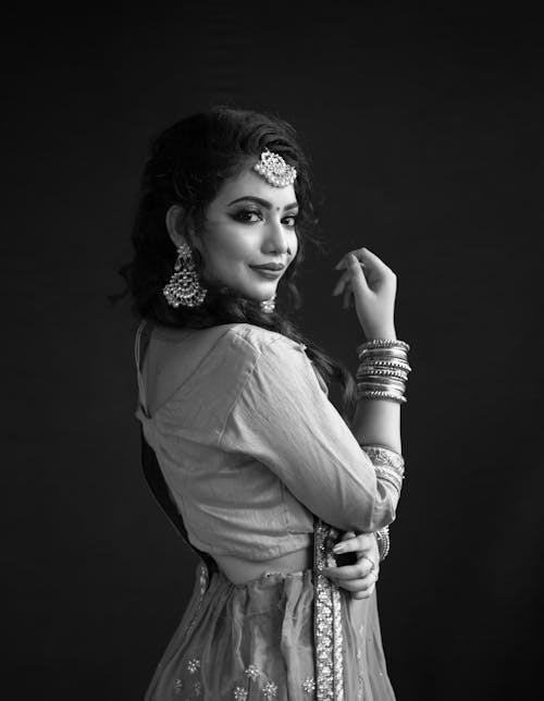 Grayscale Photo of Woman in Traditional Dress with Accessories