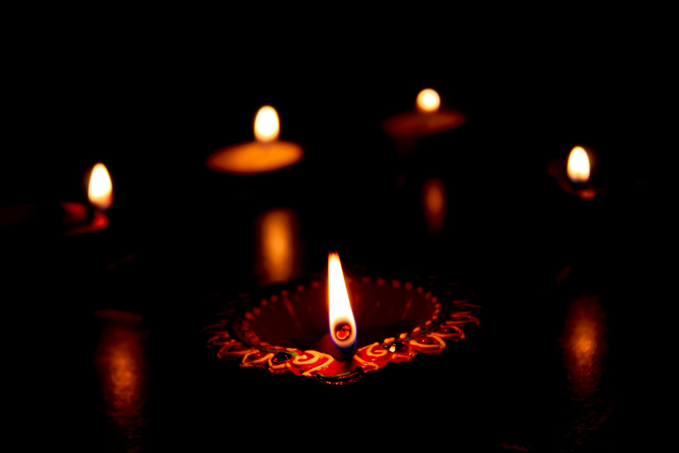 Diya in Diwali Photo by Ravi Roshan from Pexels: https://www.pexels.com/photo/lighted-candles-on-dark-background-5861723/
