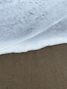 White and Brown Sand Beside Body of Water
