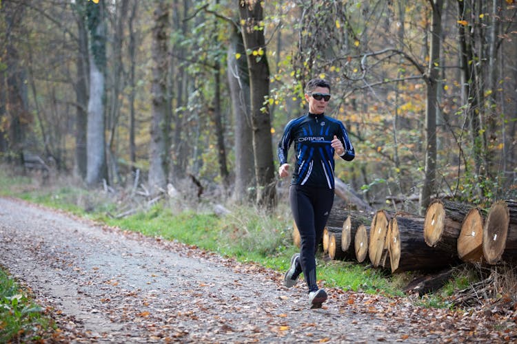 A Woman Jogging In The Forest