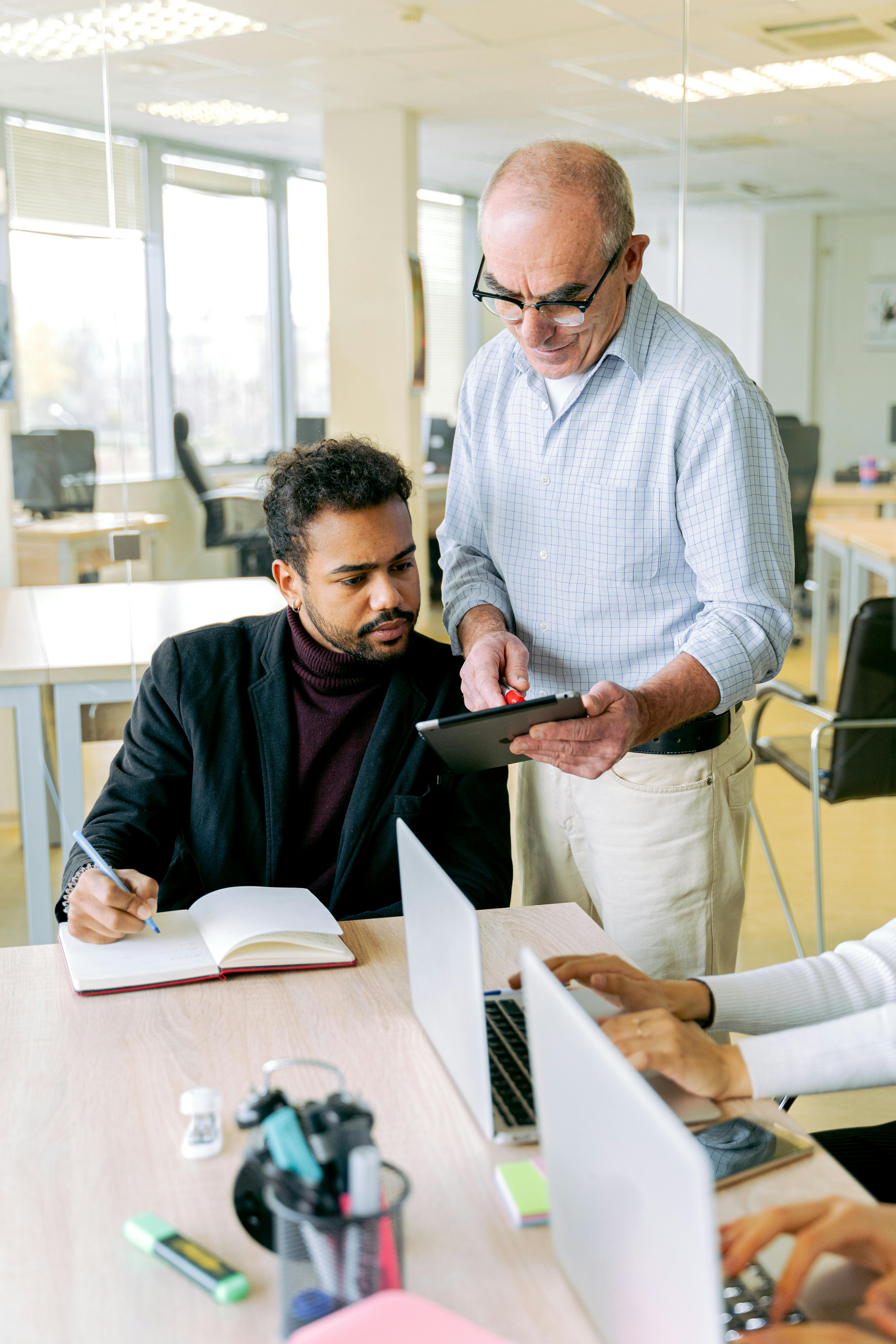Man in Black Suit Jacket Holding Black Tablet Computer
