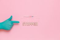 Covid-19 Stopper Text on Pink Background