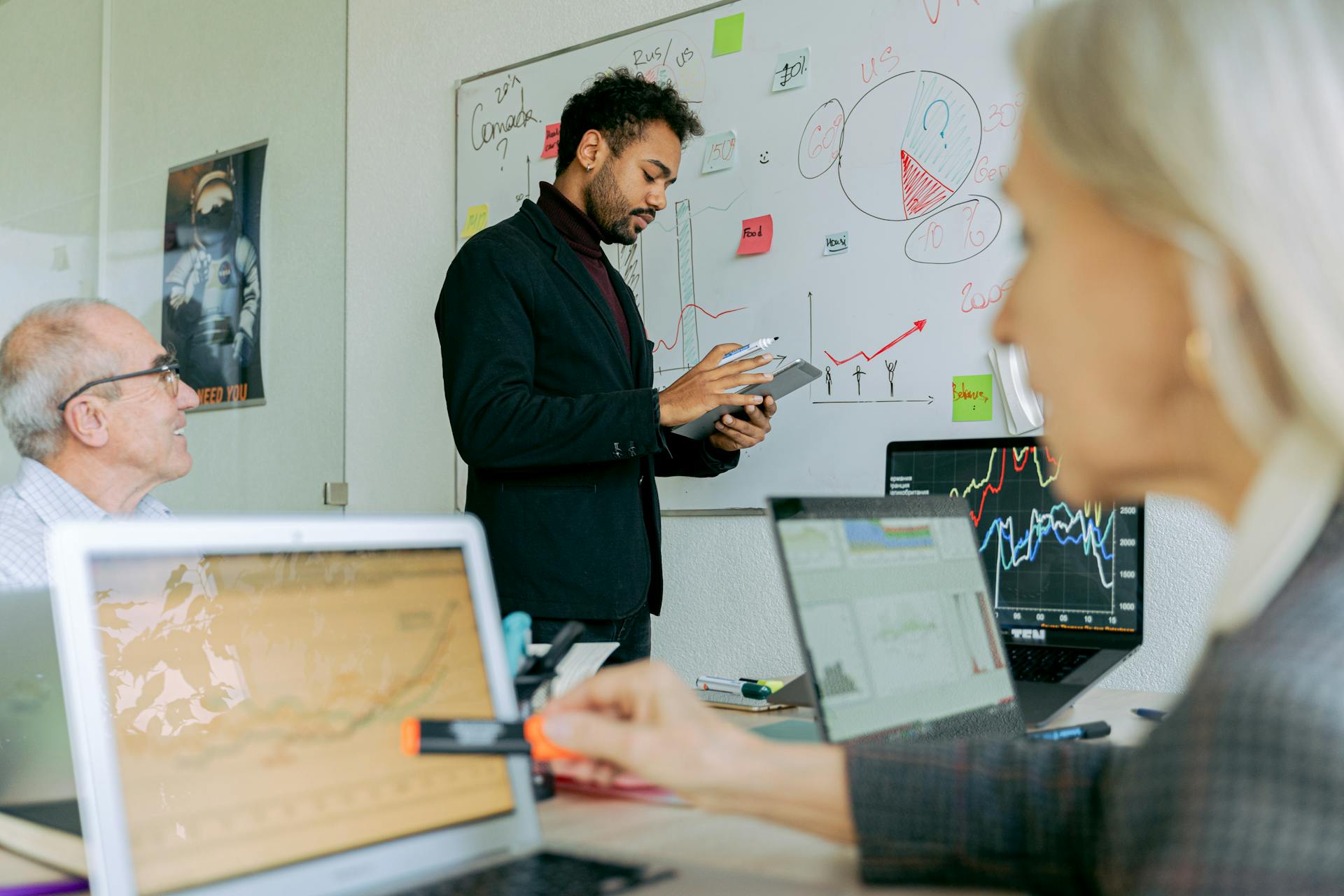 Business professionals discussing data trends in an office setting.