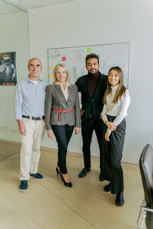 3 Women and 2 Men Standing on White Floor Tiles