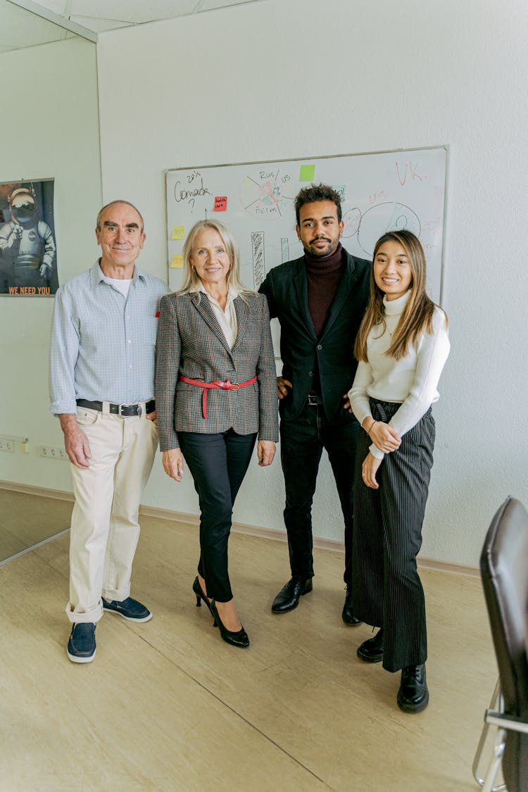 A Group Of People Standing In The Office