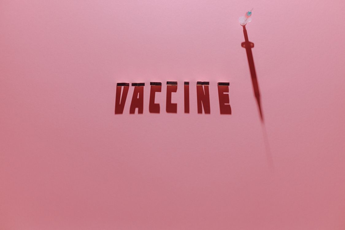 Syringe Lettering A Syringe and Vaccine Lettering Text on Pink Background · Free Stock Photo
