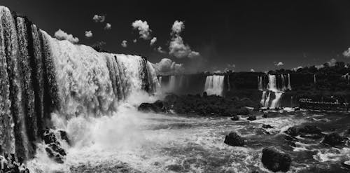Free Grayscale Photo of Waterfalls Under Cloudy Sky Stock Photo