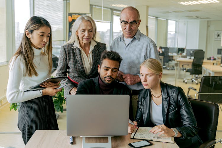 A Group Of People Having A Meeting In The Office