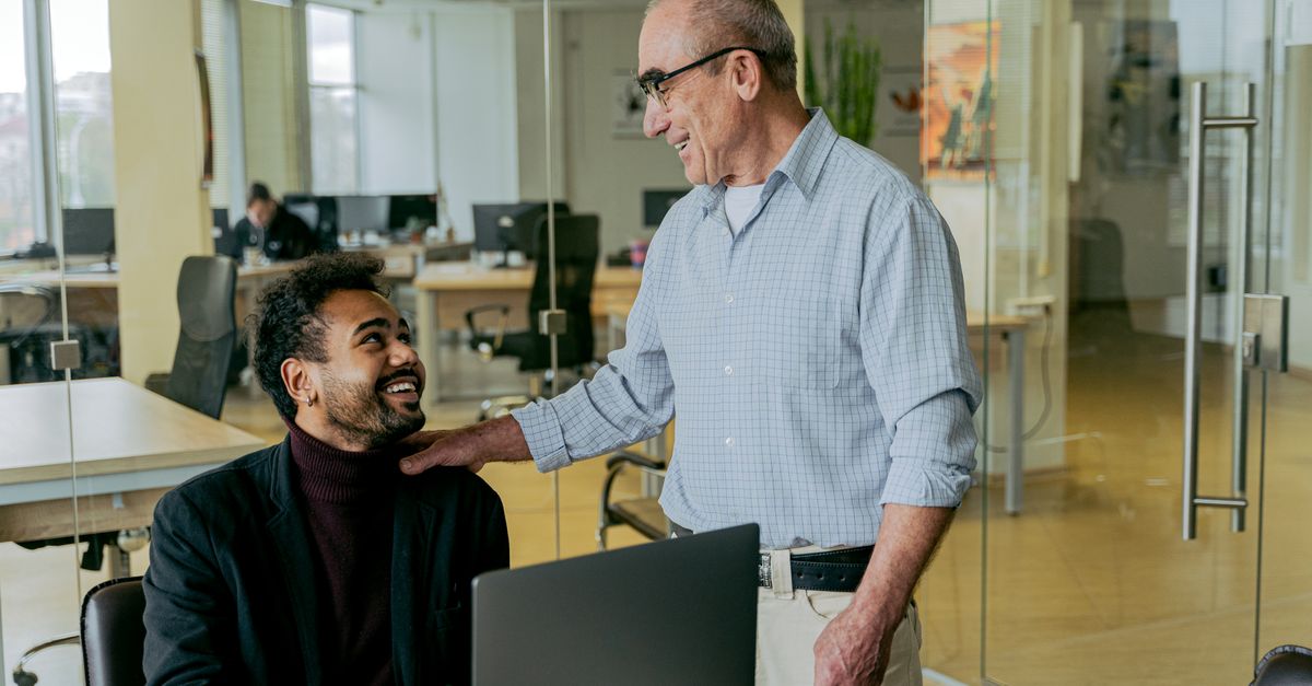 A manager and employee having a focused, positive one-on-one conversation in a bright office
