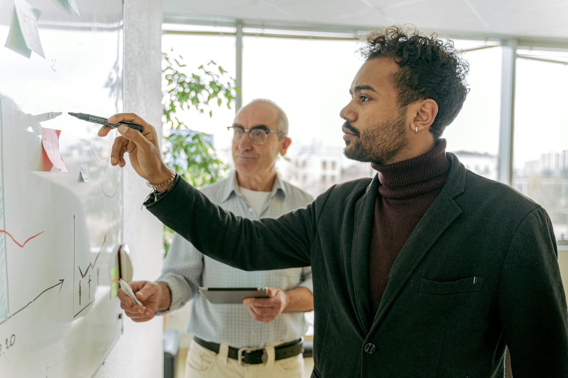 Man in Black Blazer Holding Glass Mug