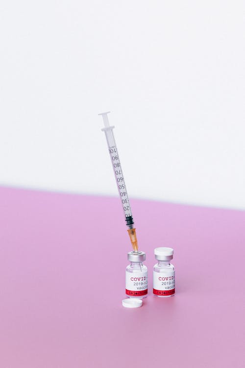 Free Preparing Covid Vaccine on Pink Surface Stock Photo