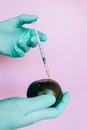 Person Injecting a Fruit by Using a Syringe
