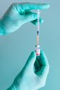 A Person Holding a Syringe and a Vial