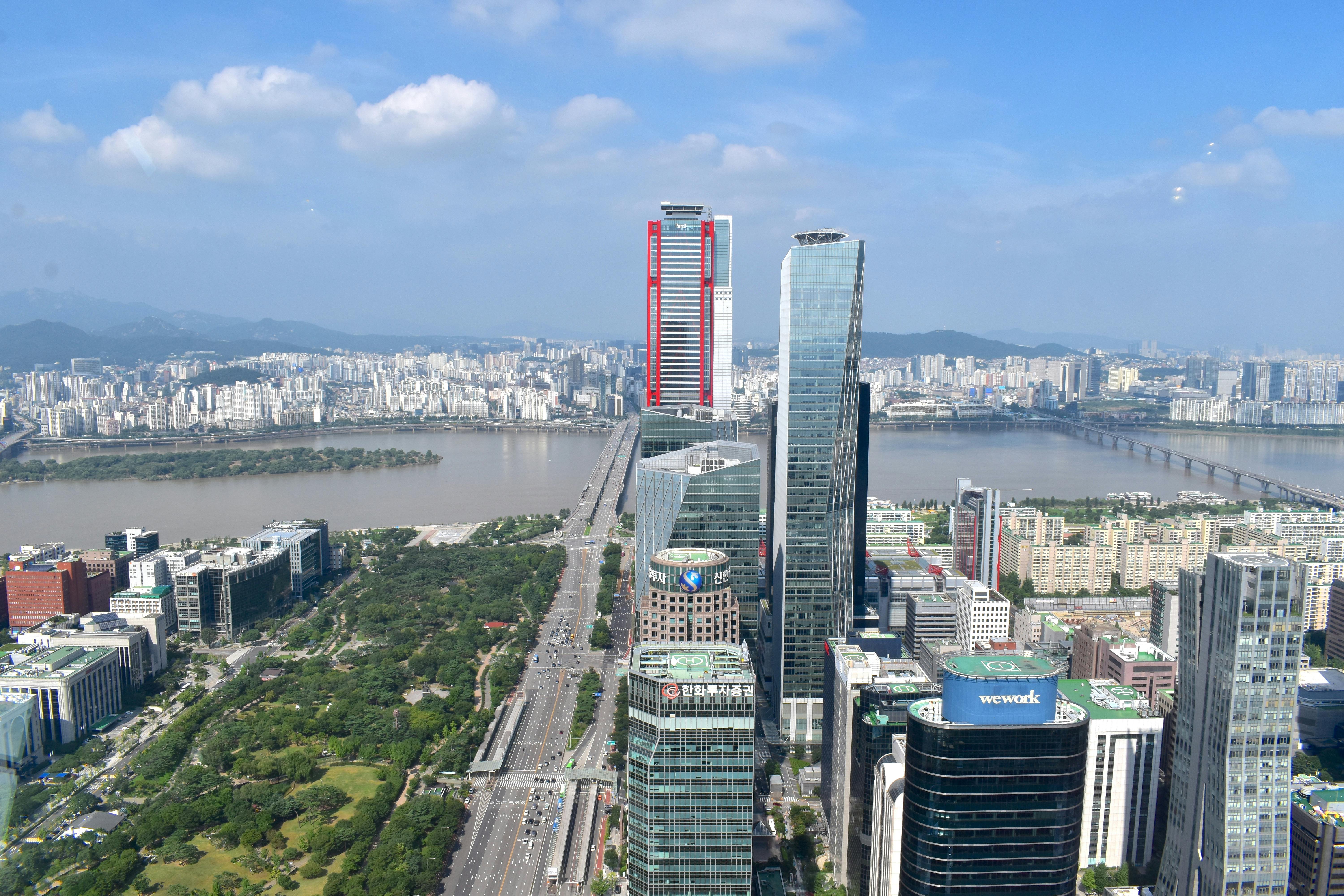 A pediatrician gently speaking with a mother holding her child in a clinic