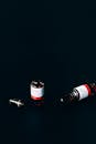 Two Vials on Black Surface