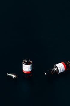 Close-up of COVID-19 vaccine vials on a dark background depicting healthcare and vaccination.