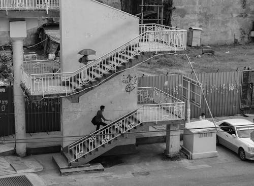 Back View Shot of People Going Up the Stairs