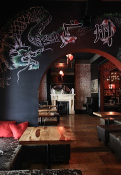 Elegant oriental-themed restaurant interior with dragon mural and wooden furniture for a warm ambiance.