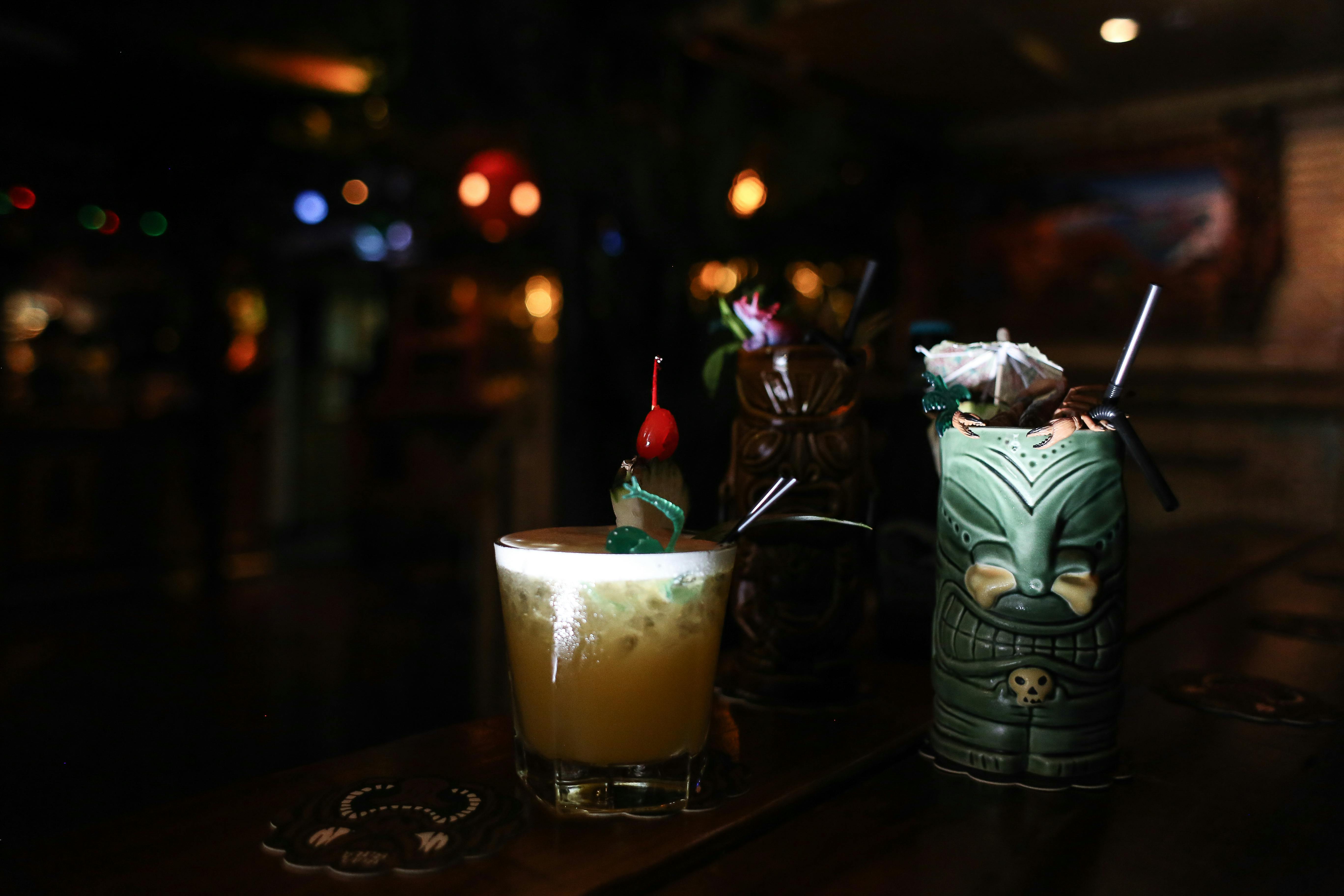Tiki drinks in colorful mugs - tiki