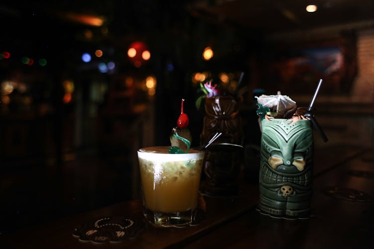 Cocktail Drinks In Clear Glass And Ceramic Tiki Mug