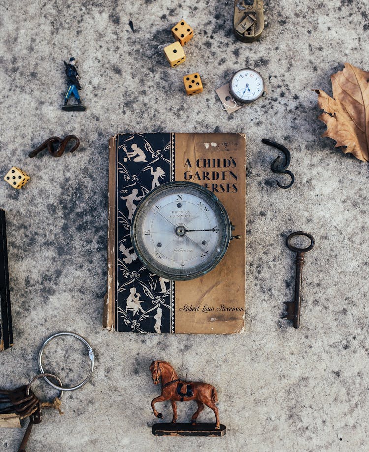 Trinkets Scattered Around Old Book