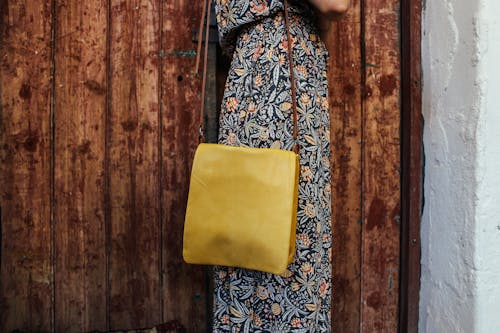 Free Person in Floral Dress with Yellow Shoulder Bag Stock Photo