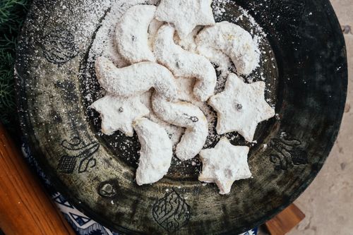 Free Delightful star and crescent cookies dusted with sugar on a rustic plate. Stock Photo