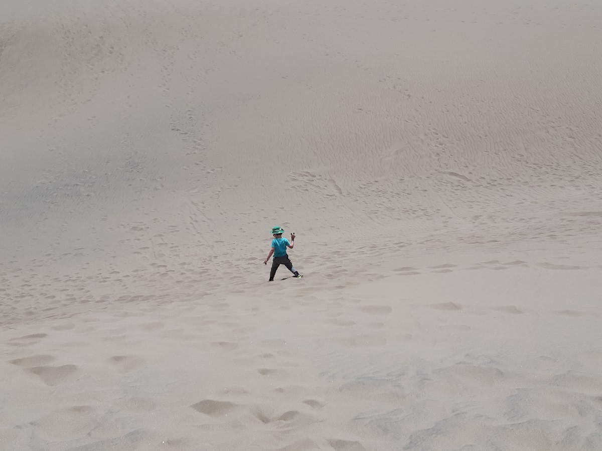 Snack plate with vegetables, dips, crackers, and a drink on a small table
