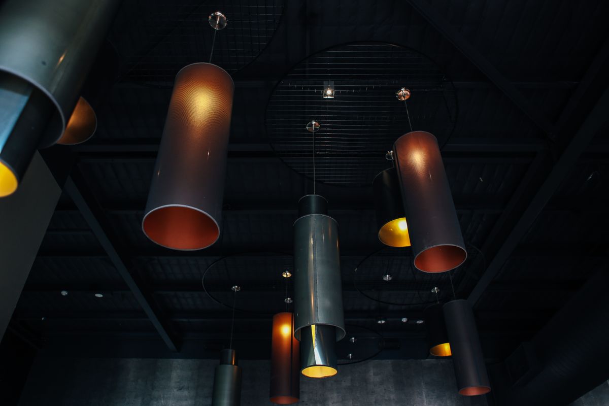 Industrial pendant lights in a dark interior — photo by Rachel Claire on Pexels