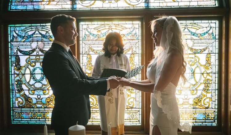 Gentle Bride And Happy Groom Getting Married In Church